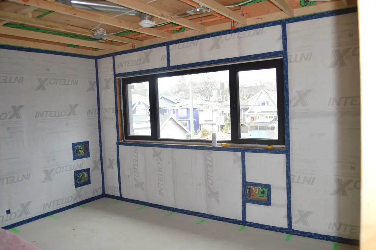 Continuous interior air barrier membrane carefully sealed around a window opening.